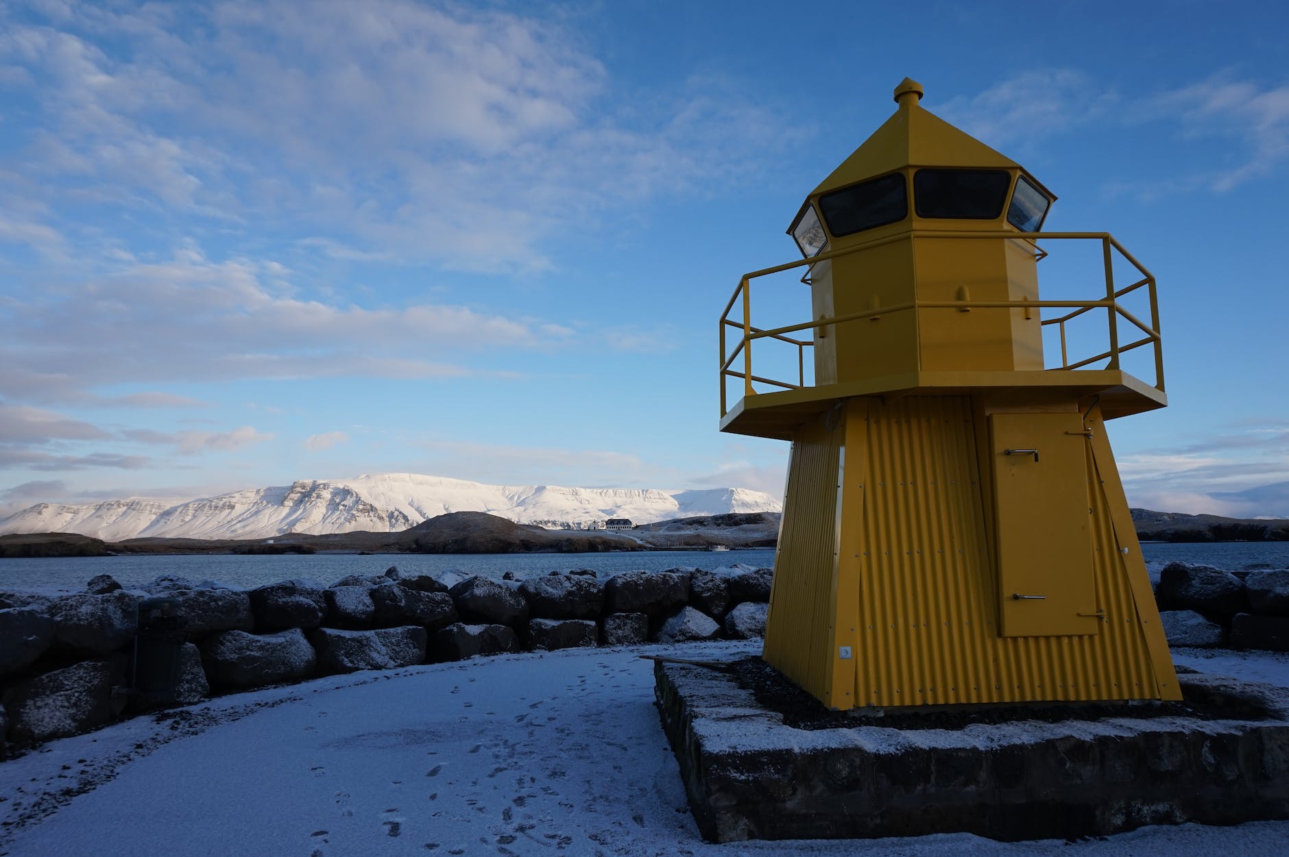Reykjavik Lighthouse with mountains Know before you go to Iceland