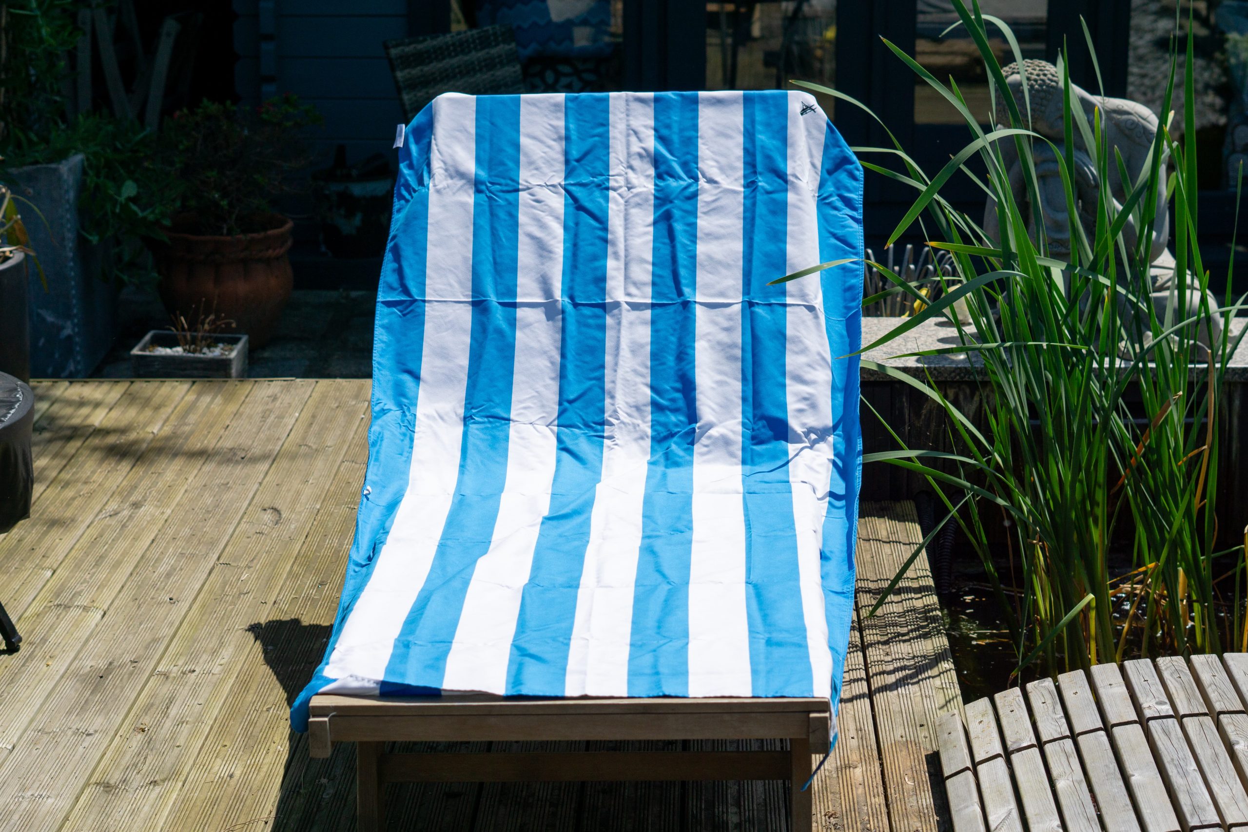 Dock and Bay Travel Towel on a a bench for a review