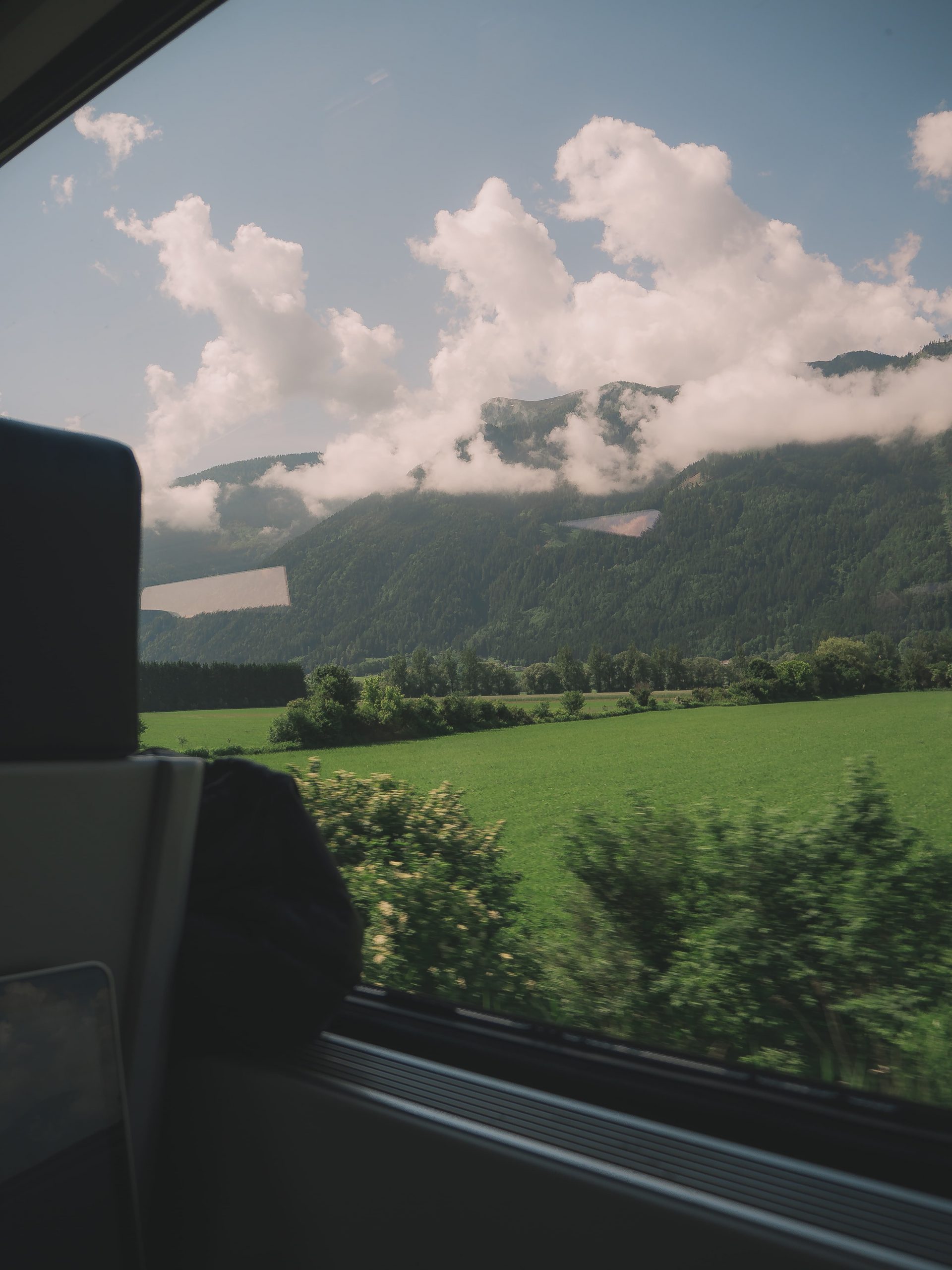Austria train window view for guest post on Brads Backpack on european train travel by Lizet from A Wanderfood Life