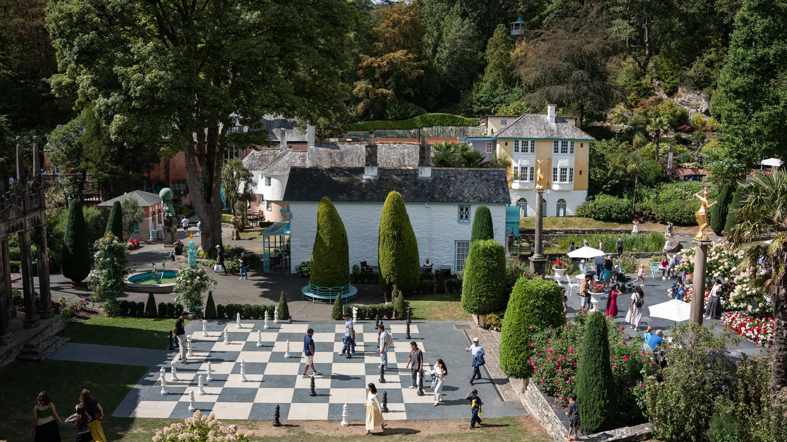 Portmeirion-3 16x9 Elevated view of Portmeirion’s Central Piazza, giant chessboard, topiary and surrounding buildings.