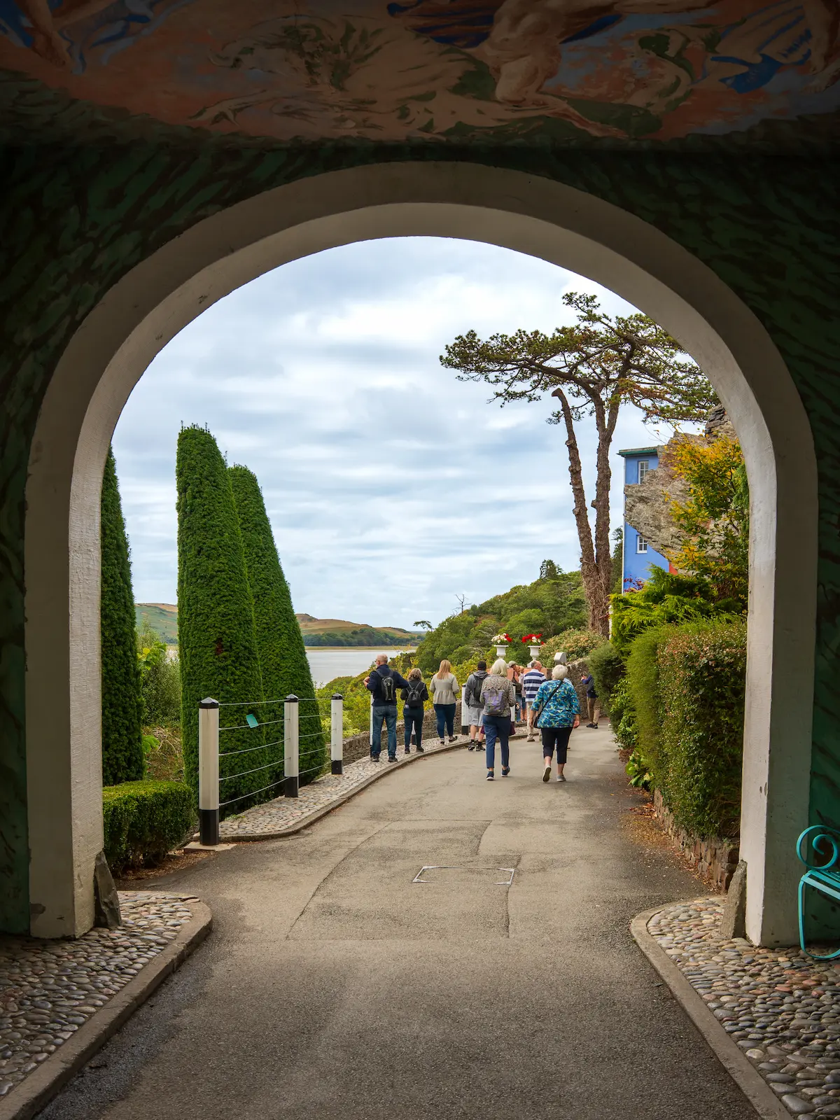 Portmeirion Arch 3x4 1. View through a painted archway towards the gardens and Dwyryd Estuary at Portmeirion.