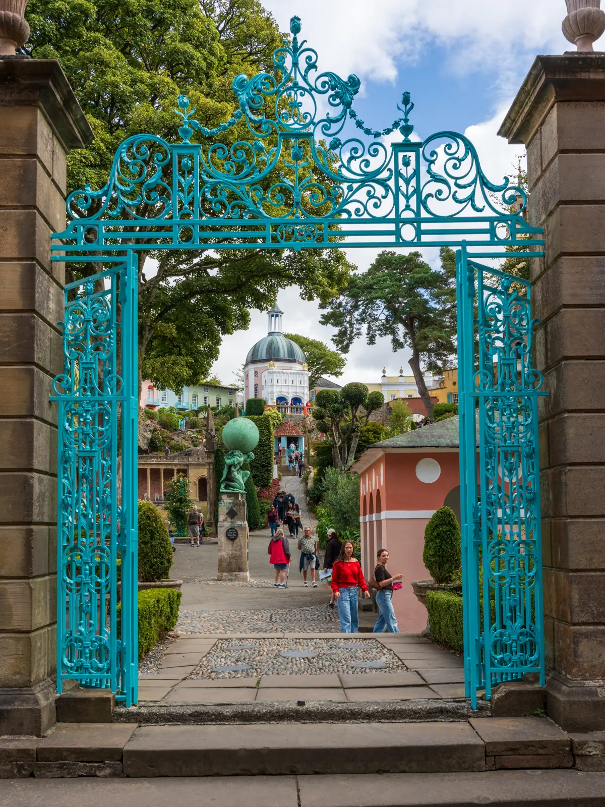 Portmeirion Gate 3x4 Ornate turquoise entrance gates framing the colourful buildings and gardens of Portmeirion village.